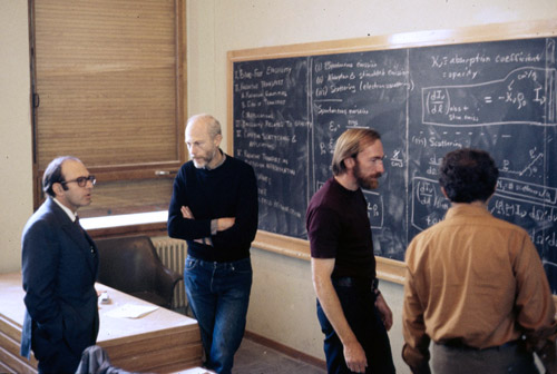 Discussion in the main lecture hall at the &Eacute;cole de Physique des Houches (Les Houches Physics School), 1972. From left, Yuval Ne&rsquo;eman, Bryce DeWitt, Kip Thorne.