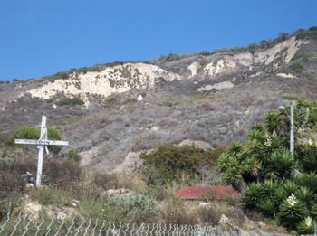 The landslide debris covering the town as of 2011, with the makeshift graves and memorials still standing from 2005. (Courtesy 2011 K. Allison Lenkeit Meezan • Foothill College, Department of Geography • About the Virtual Field Trip This work is licensed under a Creative Commons Attribution-NonCommercial-ShareAlike 3.0 Unported License.)